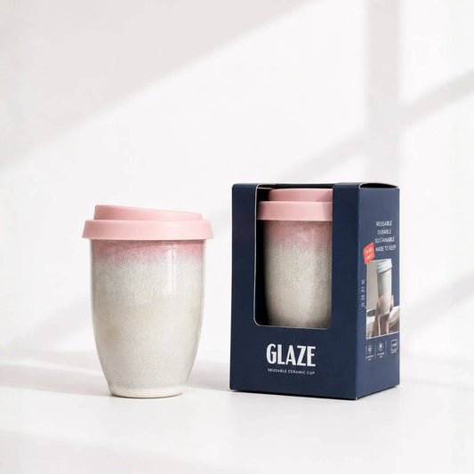 Reusable ceramic cup with pink top and packaging displaying 'Glaze' brand on a white background