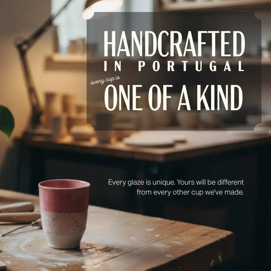 A handmade ceramic cup with a pink and white gradient glaze sits on a wooden table in a softly blurred pottery studio. Large text overlays read 'HANDCRAFTED IN PORTUGAL' and 'ONE OF A KIND', with smaller text below stating 'Every glaze is unique.