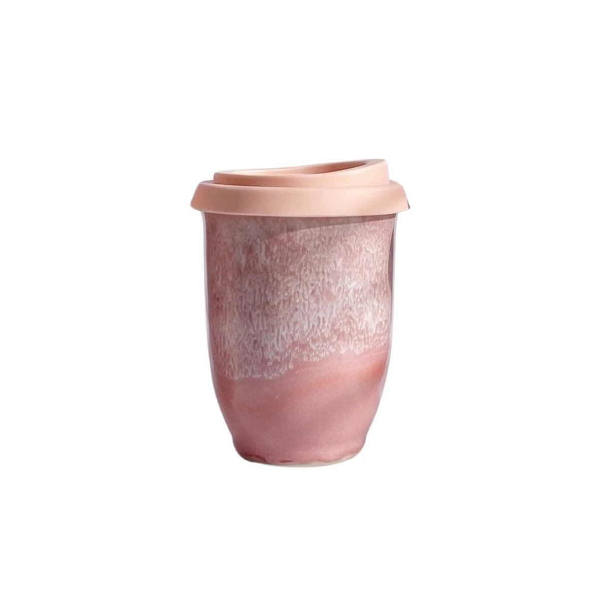 Pink ceramic cup with speckled pattern on a white background
