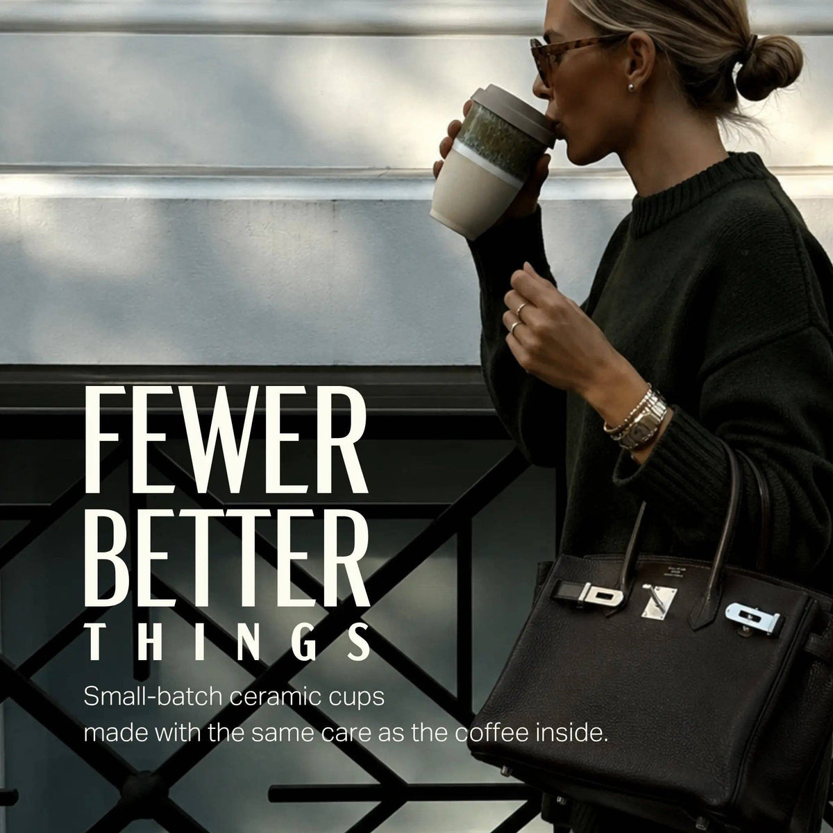 Woman drinking from a ceramic cup with text 'FEWER BETTER THINGS' and product description.