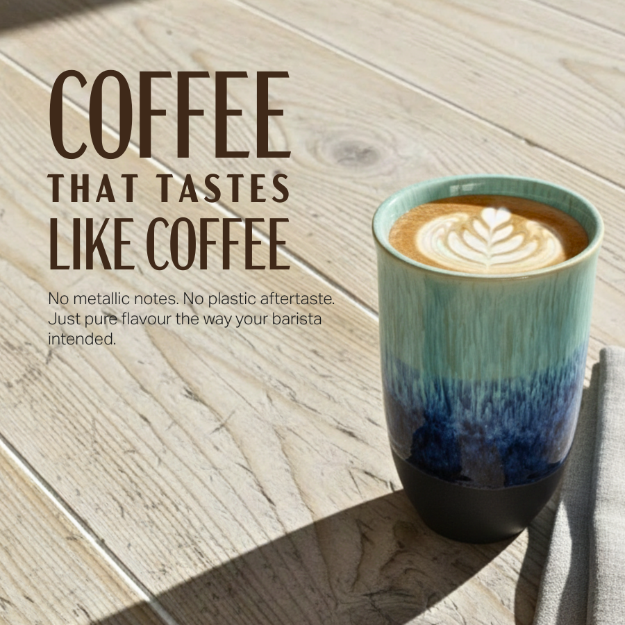 A ceramic coffee mug with a teal-to-blue gradient and a dark base, filled with latte coffee and set on a light wood tabletop. Large text on the left reads 'COFFEE THAT TASTES LIKE COFFEE' with smaller descriptive copy below.