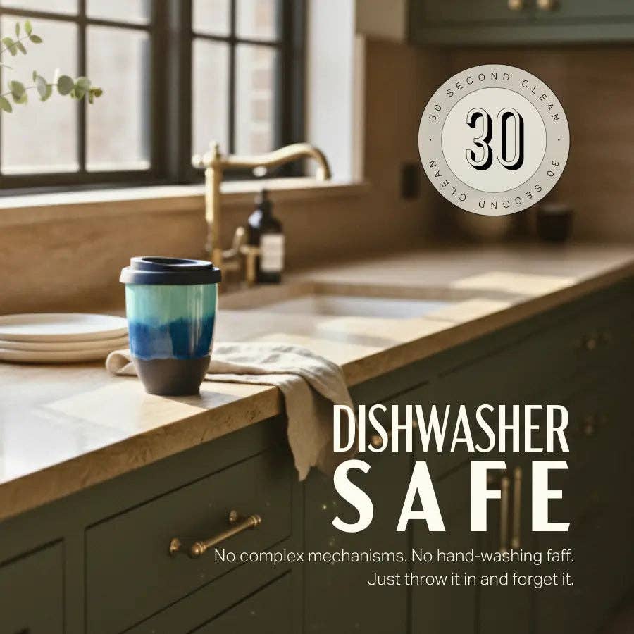 A ceramic travel tumbler with a blue gradient design and a dark lid sits on a kitchen counter next to a sink, with text overlays reading 'DISHWASHER SAFE' and a circular badge that says '30 SECOND CLEAN'.