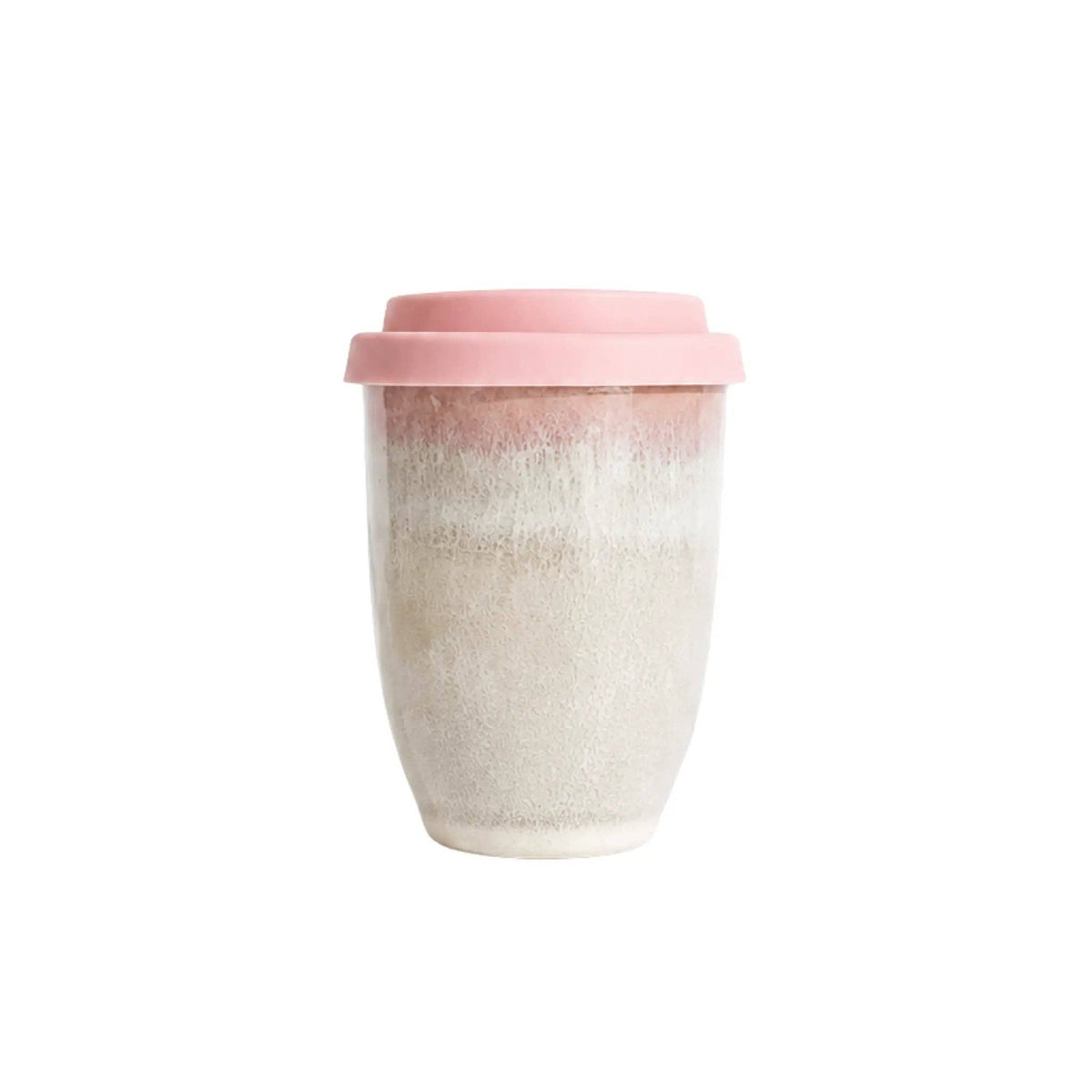 A reusable ceramic travel mug with a pink lid, featuring a gradient design that transitions from a dusty rose pink at the top to a speckled off-white and light beige at the bottom, set against a plain white background.